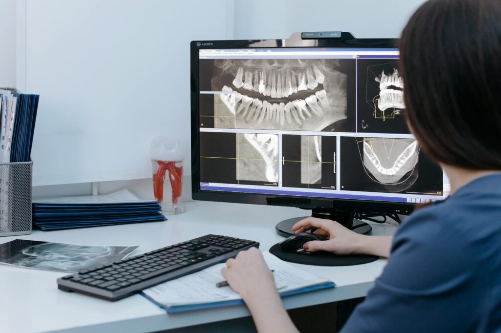 a person looking at xray image of teeth